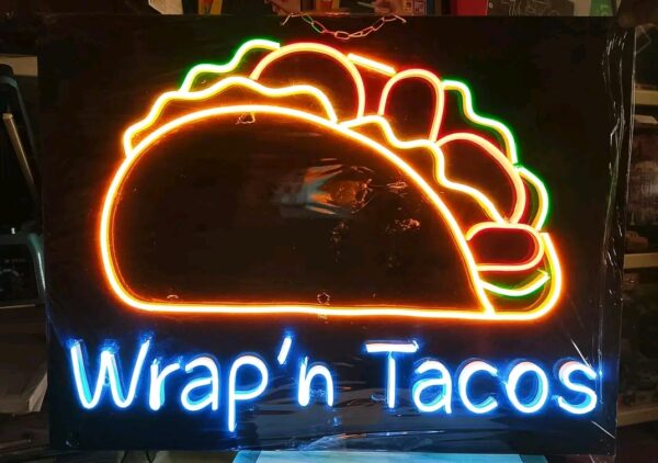 Functional signs for storefronts including "OPEN", "SALE", and branded logos for "Wrap N Tacos".